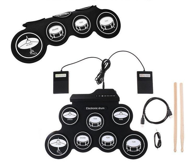 Drum kit rolled up and laid flat with two foot pedals, USB cable and drumsticks